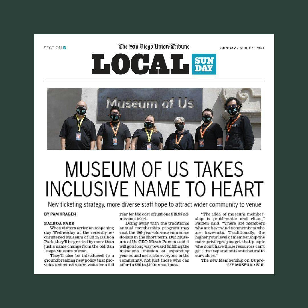 A screenshot of a San Diego Union-Tribune article from the local section titled, "Museum of Us Takes Inclusive Name to Heart." The article features an images of six museum staff members dressed in black standing before a metal "Museum of Us" sign.